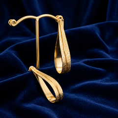 Gold Fluid Loop Earrings With Textured Open Frame