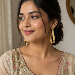 Gold Fluid Loop Earrings With Textured Open Frame
