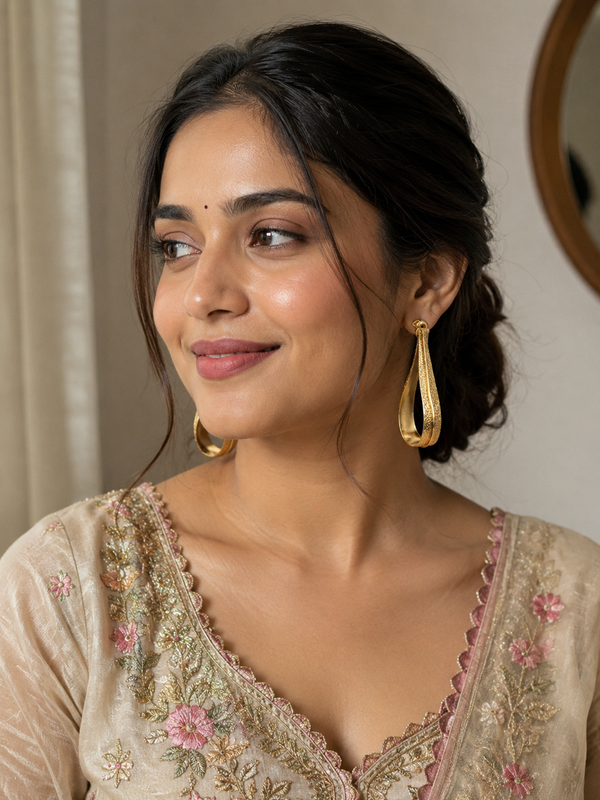 Gold Fluid Loop Earrings With Textured Open Frame